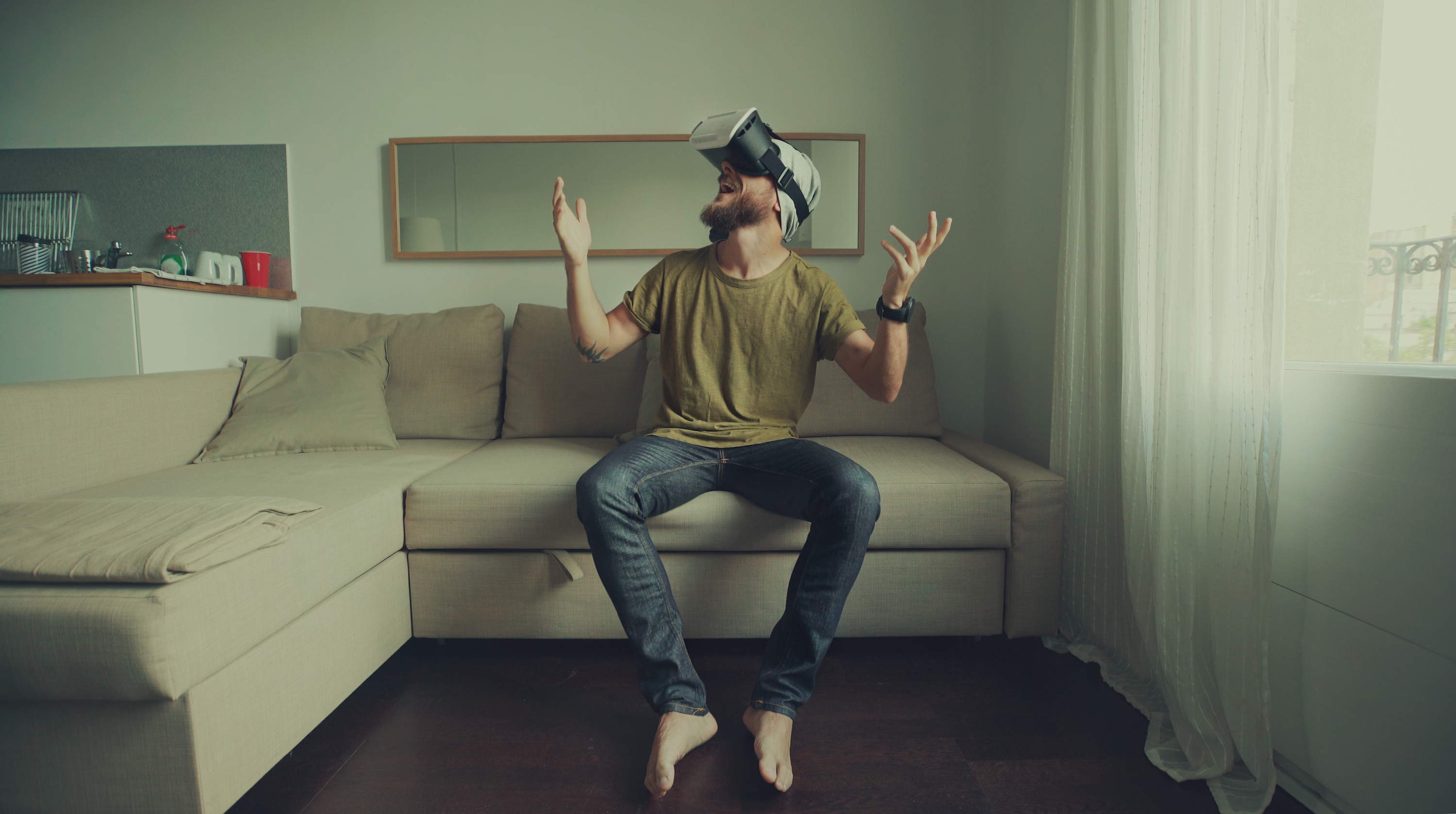 iStock-612843836%20-%20Man%20wearing%20virtual%20reality%20headset%20at%20home.jpg